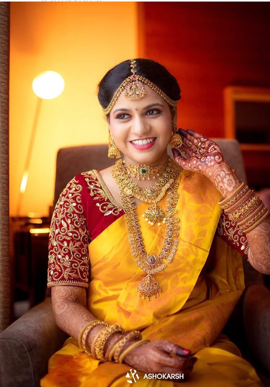 Bride in yellow silk saree, bridal makeup by Aroma Natures